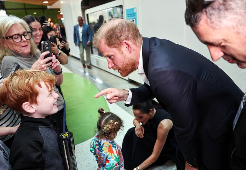 Prince Harry and Meghan arrive in Australia to a muted welcome